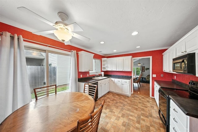 4713 N Cypress Ct, Oklahoma City, OK 73162 - kitchen with electric range, dark countertops, a ceiling fan, white cabinetry, and ornamental molding