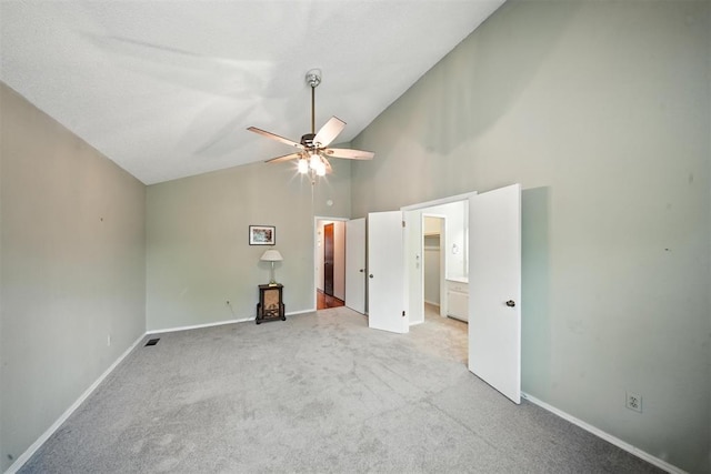 4713 N Cypress Ct, Oklahoma City, OK 73162 - unfurnished bedroom with high vaulted ceiling, carpet floors, a walk in closet, and a ceiling fan