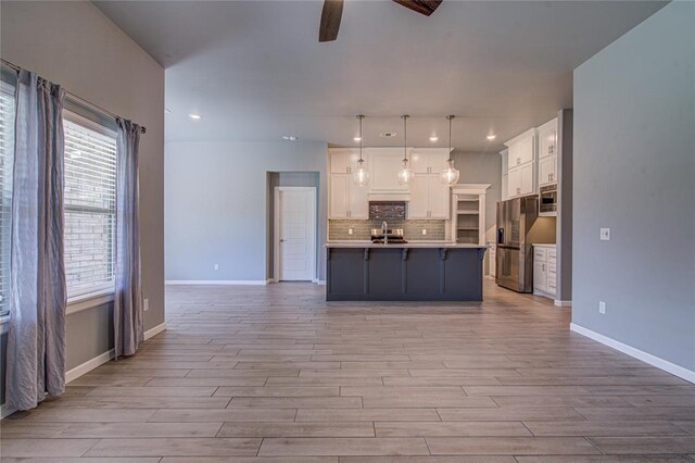 3800 Palmetto Trl, Oklahoma City, OK 73179 - kitchen with ceiling fan, stainless steel refrigerator with ice dispenser, light wood-style flooring, decorative backsplash, and white cabinetry