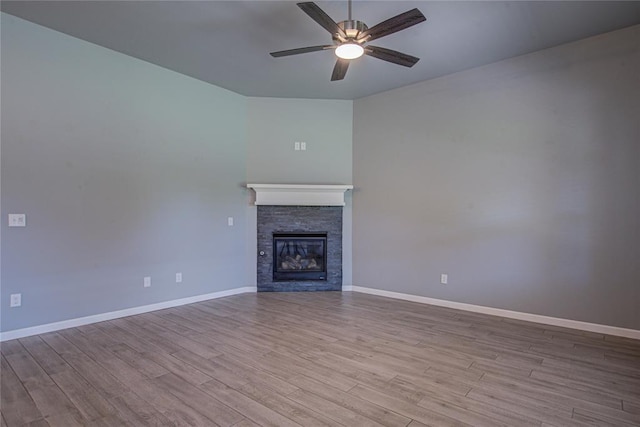 3800 Palmetto Trl, Oklahoma City, OK 73179 - unfurnished living room with ceiling fan, wood finished floors, and a stone fireplace