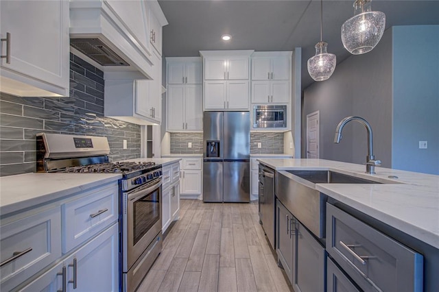 3800 Palmetto Trl, Oklahoma City, OK 73179 - kitchen with appliances with stainless steel finishes, custom exhaust hood, recessed lighting, light stone counters, and white cabinets