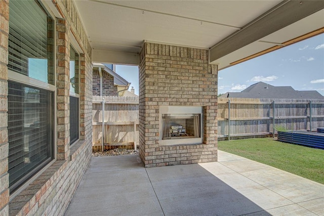 3800 Palmetto Trl, Oklahoma City, OK 73179 - fenced backyard featuring an outdoor brick fireplace and a patio