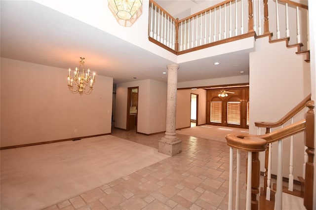 12608 Redstone Ct, Oklahoma City, OK 73142 - entryway with ornate columns, stairs, a chandelier, a towering ceiling, and recessed lighting