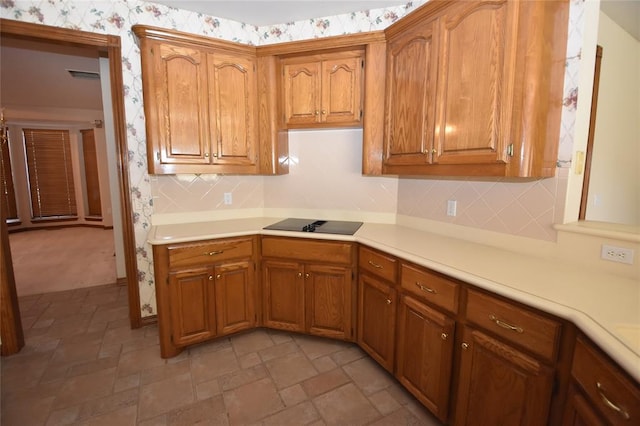 12608 Redstone Ct, Oklahoma City, OK 73142 - kitchen featuring light countertops, wallpapered walls, brown cabinetry, and decorative backsplash