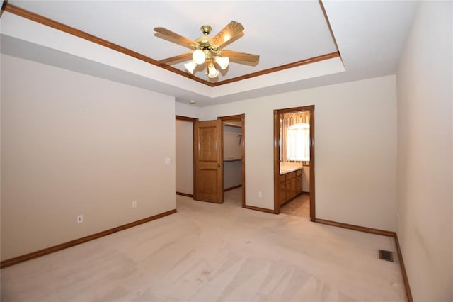 12608 Redstone Ct, Oklahoma City, OK 73142 - unfurnished bedroom featuring a raised ceiling, light carpet, a walk in closet, connected bathroom, and a closet
