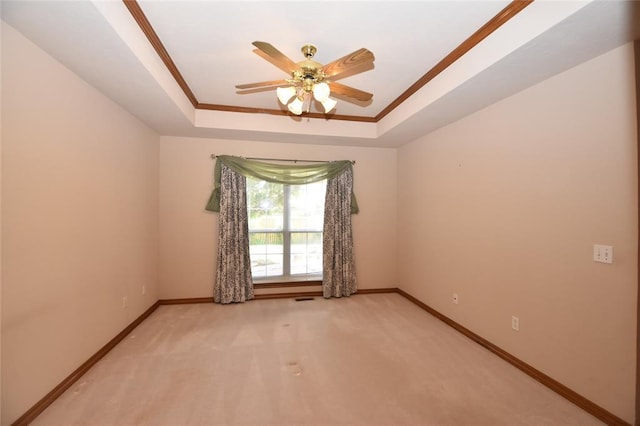 12608 Redstone Ct, Oklahoma City, OK 73142 - spare room featuring a raised ceiling, ceiling fan, light colored carpet, and crown molding
