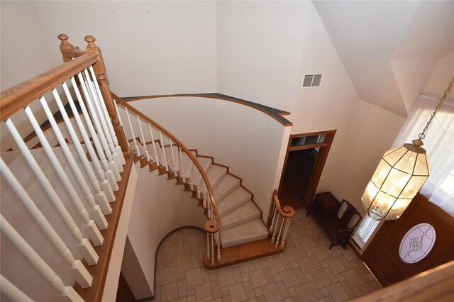 12608 Redstone Ct, Oklahoma City, OK 73142 - stairs featuring vaulted ceiling and a chandelier