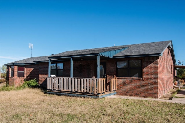 23281 N Pvt 3227 Dr, Pauls Valley, OK 73075 - view of front of home with a porch, brick siding, a front lawn, and roof with shingles
