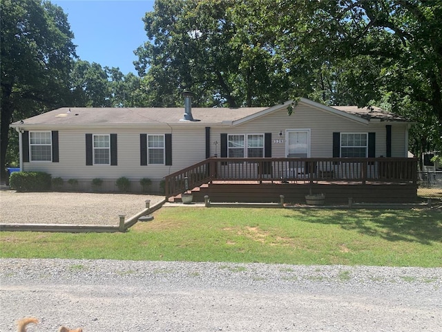128 N Buffalo St, Canadian, OK 74425 - manufactured / mobile home featuring a front lawn and a deck
