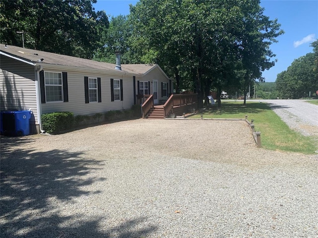 128 N Buffalo St, Canadian, OK 74425 - manufactured / mobile home with a deck and gravel driveway