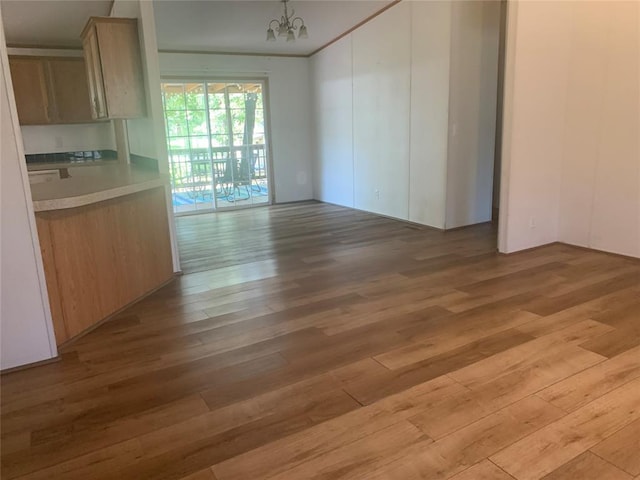 128 N Buffalo St, Canadian, OK 74425 - unfurnished dining area with light wood-style floors and a chandelier