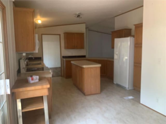 128 N Buffalo St, Canadian, OK 74425 - kitchen featuring white fridge with ice dispenser, a center island, light countertops, and light floors