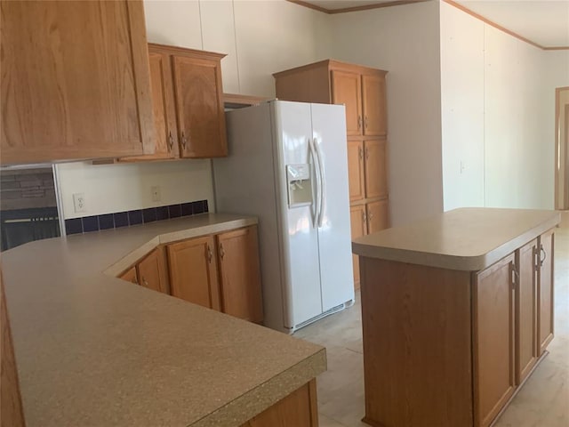 128 N Buffalo St, Canadian, OK 74425 - kitchen with white refrigerator with ice dispenser, crown molding, a kitchen island, and light countertops