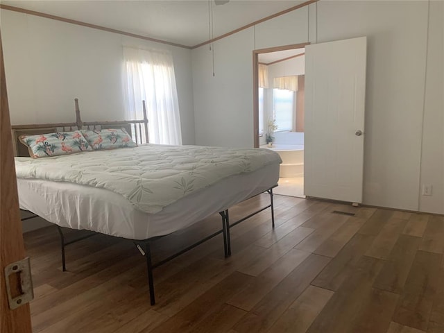 128 N Buffalo St, Canadian, OK 74425 - bedroom with wood finished floors, multiple windows, crown molding, and connected bathroom