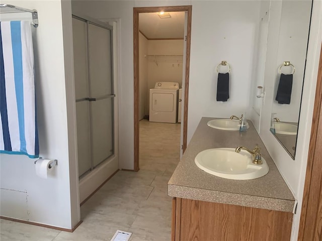 128 N Buffalo St, Canadian, OK 74425 - full bathroom featuring a stall shower, double vanity, a walk in closet, and independent washer and dryer