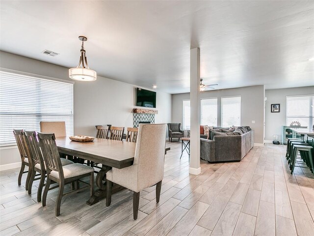 1417 Atalon Dr, Moore, OK 73160 - dining area with light wood-style floors, a fireplace, and ceiling fan