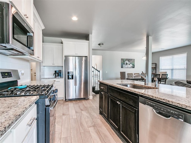1417 Atalon Dr, Moore, OK 73160 - kitchen with appliances with stainless steel finishes, white cabinets, light stone countertops, and recessed lighting