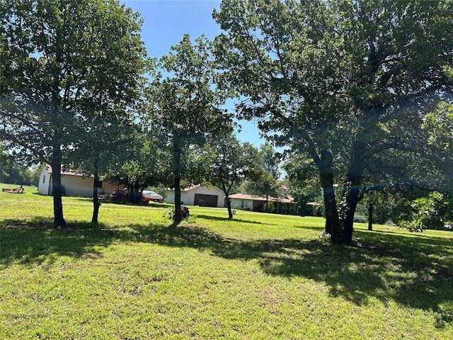 344393 E 930th Rd, Chandler, OK 74834 - view of green lawn featuring a garage