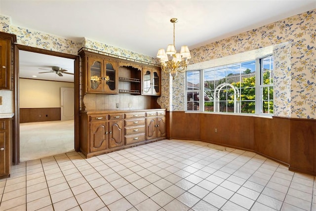 2709 NW 60th St, Oklahoma City, OK 73112 - unfurnished dining area with a wainscoted wall, wallpapered walls, a chandelier, light tile patterned floors, and a ceiling fan