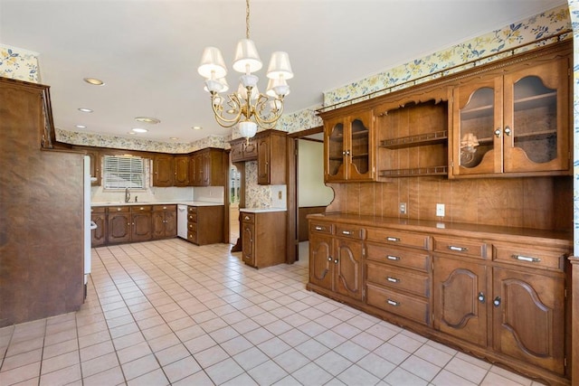 2709 NW 60th St, Oklahoma City, OK 73112 - kitchen with a chandelier, light tile patterned floors, glass insert cabinets, hanging light fixtures, and wallpapered walls