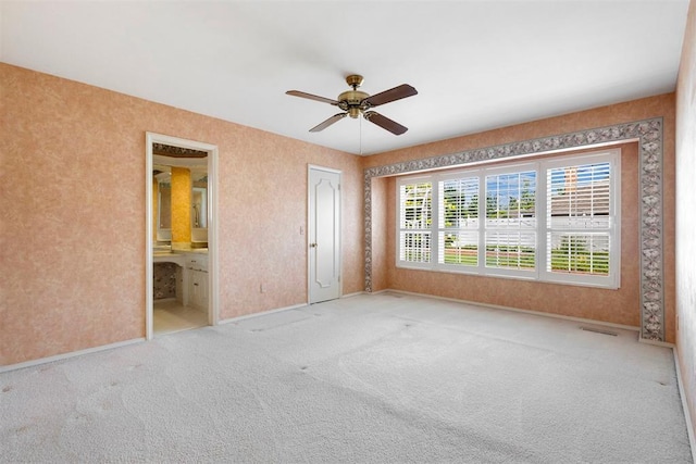 2709 NW 60th St, Oklahoma City, OK 73112 - unfurnished bedroom with carpet floors, a ceiling fan, and ensuite bathroom