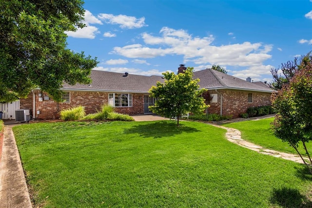 2709 NW 60th St, Oklahoma City, OK 73112 - ranch-style house featuring brick siding, a front yard, a patio area, and a chimney