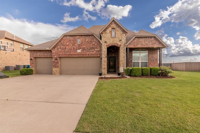 3101 Firewheel Rd, Edmond, OK 73013 - view of front of property featuring brick siding, an attached garage, concrete driveway, stone siding, and roof with shingles