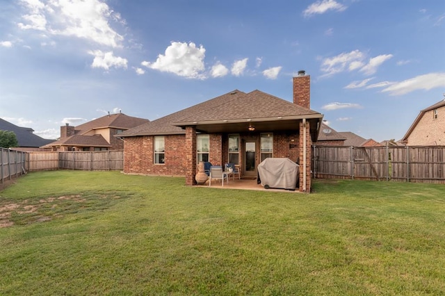 3101 Firewheel Rd, Edmond, OK 73013 - rear view of property with brick siding, a chimney, a fenced backyard, roof with shingles, and a patio