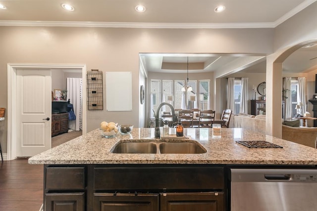 3101 Firewheel Rd, Edmond, OK 73013 - kitchen with dishwasher, open floor plan, arched walkways, light stone countertops, and a center island with sink