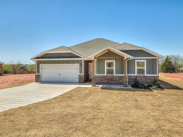 13172 Mannington Rd, Edmond, OK 73025 - craftsman-style house featuring a garage, brick siding, driveway, and a front lawn