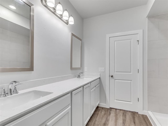 13172 Mannington Rd, Edmond, OK 73025 - bathroom with double vanity and wood finished floors