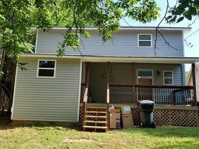 rear view of house featuring a lawn
