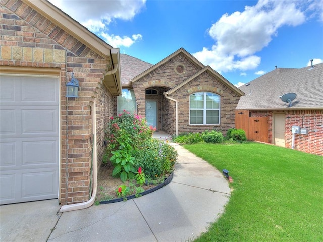 12824 NW 6th St, Yukon, OK 73099 - entrance to property with a garage, a yard, and brick siding