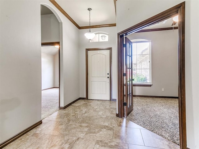 12824 NW 6th St, Yukon, OK 73099 - foyer featuring light colored carpet, arched walkways, and ornamental molding