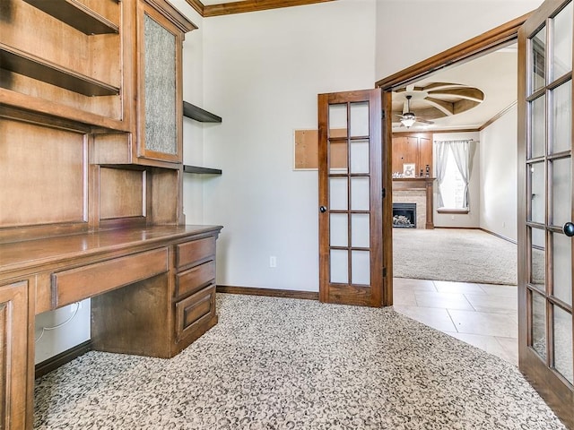 12824 NW 6th St, Yukon, OK 73099 - unfurnished office with carpet floors, french doors, ornamental molding, ceiling fan, and a fireplace