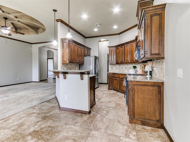 12824 NW 6th St, Yukon, OK 73099 - kitchen with arched walkways, appliances with stainless steel finishes, a ceiling fan, ornamental molding, and a peninsula