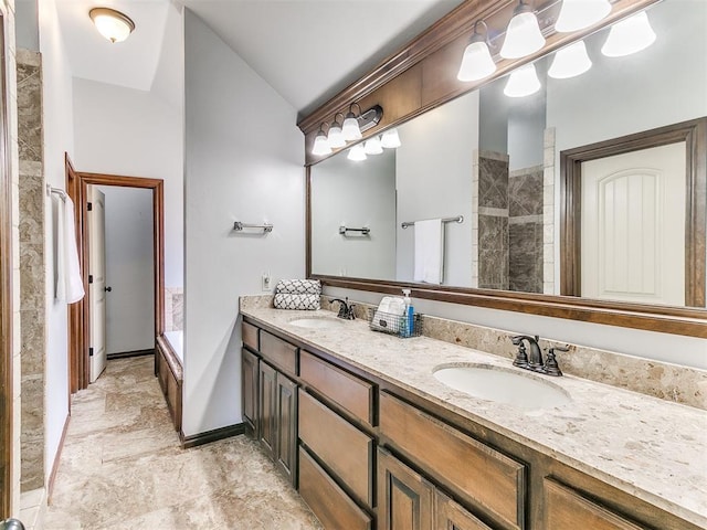 12824 NW 6th St, Yukon, OK 73099 - full bathroom with double vanity, vaulted ceiling, and tiled shower