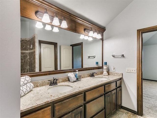 12824 NW 6th St, Yukon, OK 73099 - bathroom featuring double vanity and lofted ceiling
