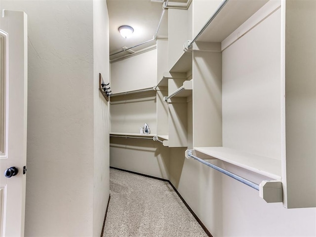12824 NW 6th St, Yukon, OK 73099 - walk in closet featuring light colored carpet