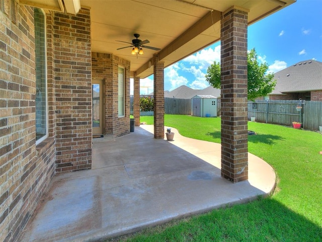 12824 NW 6th St, Yukon, OK 73099 - fenced backyard featuring ceiling fan, a storage shed, and a patio area