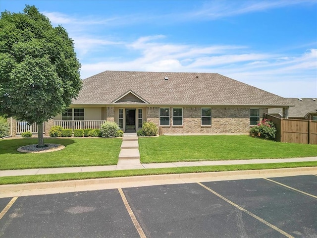 600 Nathan Way, Yukon, OK 73099 - ranch-style home featuring uncovered parking, a shingled roof, and brick siding