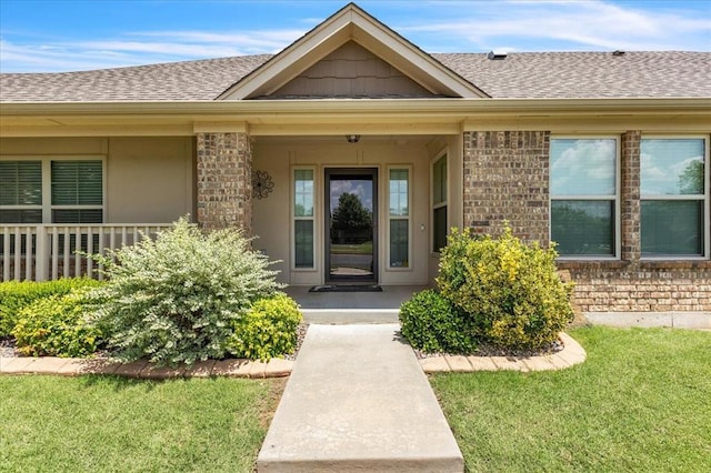 600 Nathan Way, Yukon, OK 73099 - doorway to property with brick siding, a shingled roof, and a lawn
