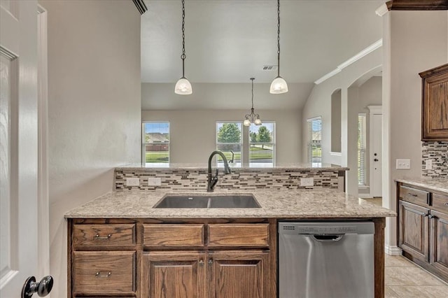 600 Nathan Way, Yukon, OK 73099 - kitchen with stainless steel dishwasher, backsplash, vaulted ceiling, light stone countertops, and decorative light fixtures