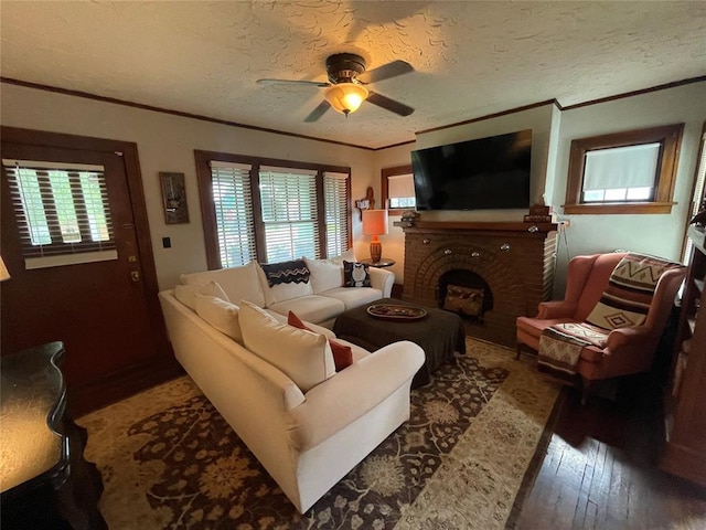1845 W Park Pl, Oklahoma City, OK 73106 - living area with ornamental molding, a ceiling fan, wood finished floors, a fireplace, and a textured ceiling