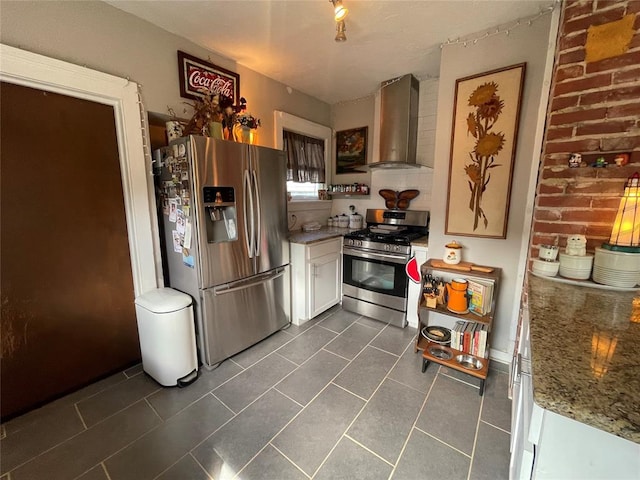 1845 W Park Pl, Oklahoma City, OK 73106 - kitchen featuring wall chimney exhaust hood, appliances with stainless steel finishes, light stone countertops, white cabinets, and dark tile patterned floors
