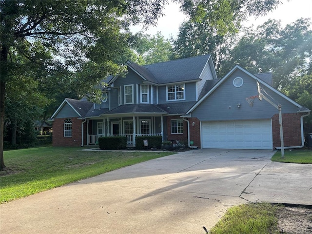 1800 N Elm Ave, Shawnee, OK 74804 - view of front of property with a porch, concrete driveway, an attached garage, brick siding, and a front yard