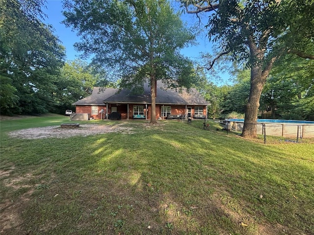 1800 N Elm Ave, Shawnee, OK 74804 - rear view of house with a yard, an outdoor pool, and brick siding