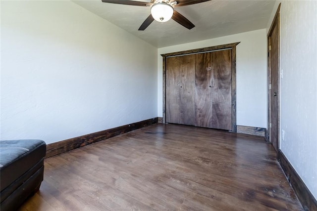 22807 E 1070th Rd, Clinton, OK 73601 - unfurnished bedroom featuring wood finished floors, ceiling fan, and a closet