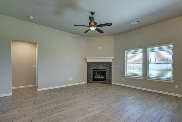 9120 NW 123rd St, Yukon, OK 73099 - unfurnished living room with a ceiling fan, light wood-style floors, and a fireplace