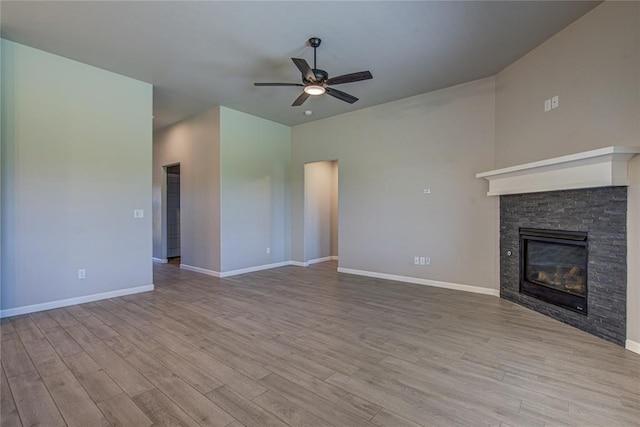 9120 NW 123rd St, Yukon, OK 73099 - unfurnished living room with a ceiling fan, wood finished floors, and a fireplace